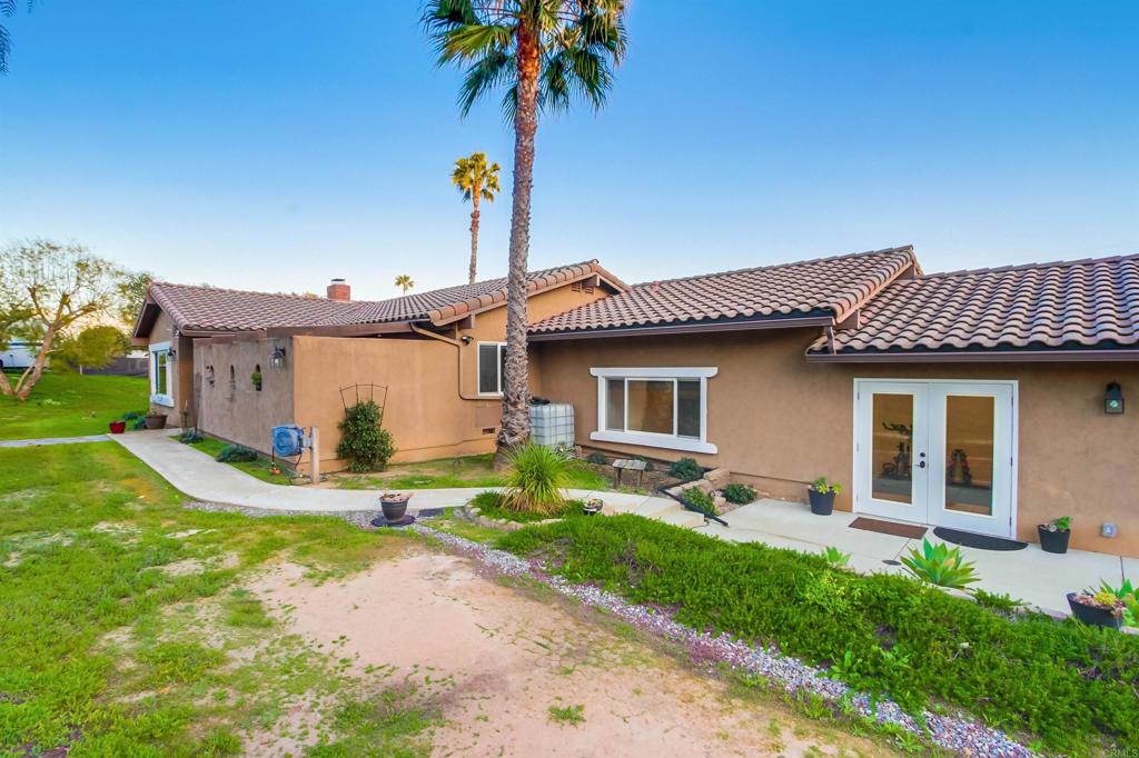 1321 Friends Way Fallbrook, CA 92028 - Photo 55 of 71 a front view of a house with a garden and patio
