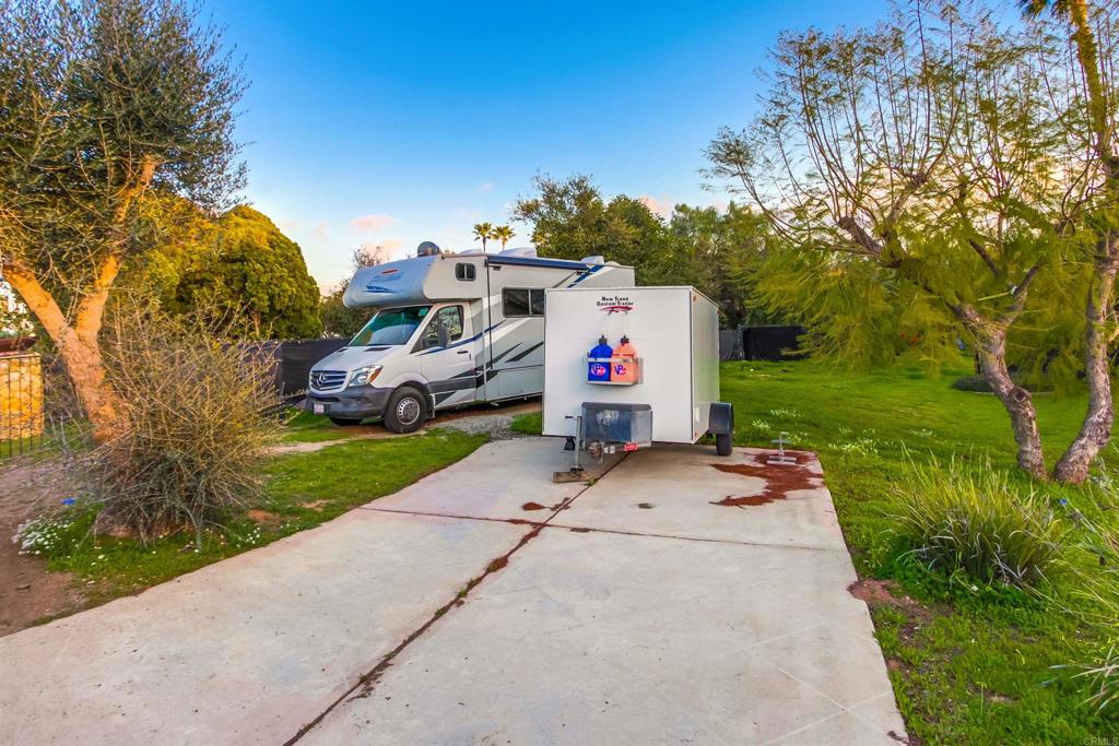 1321 Friends Way Fallbrook, CA 92028 - Photo 71 of 71 a front view of a house with a yard and garage