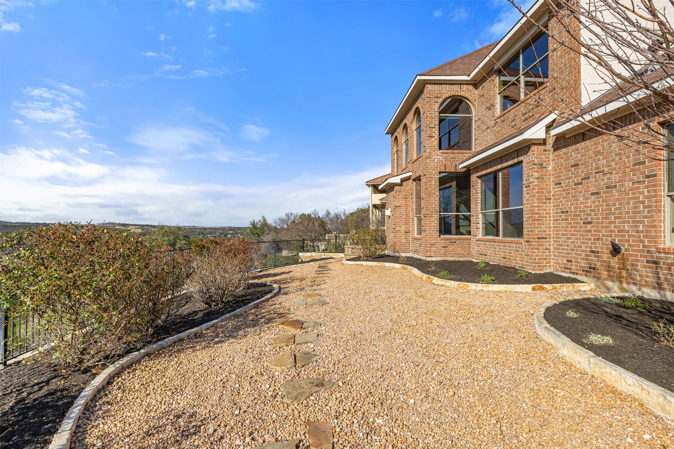 2702 Lakehurst Road Spicewood, TX 78669 - Photo 40 of 40 The xeriscaped backyard is great for the low maintenance lifestyle, but can be easily converted to grass for plenty of area to play.