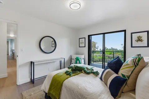 a bedroom with a bed and a night stand