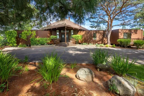 a front view of a house with garden