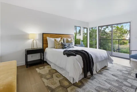 a view of walk in closet with wooden floor and a window