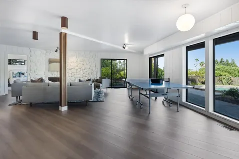 a living room with furniture and wooden floor