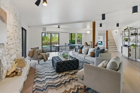 a living room with a bed and a window