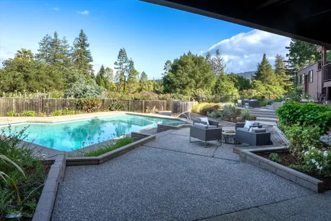an aerial view of a house with garden space and street view