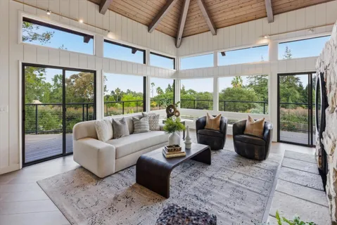 a view of a balcony with chairs and wooden floor