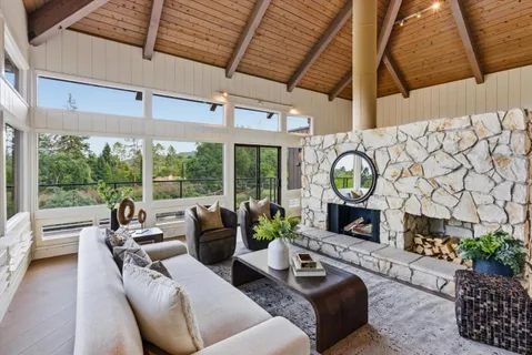 a balcony with wooden floor and outdoor seating