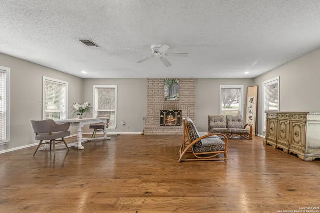 a living room with furniture and wooden floor