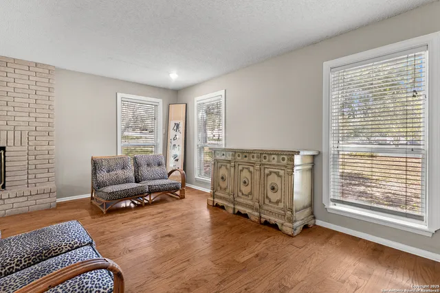 a living room with furniture and large windows