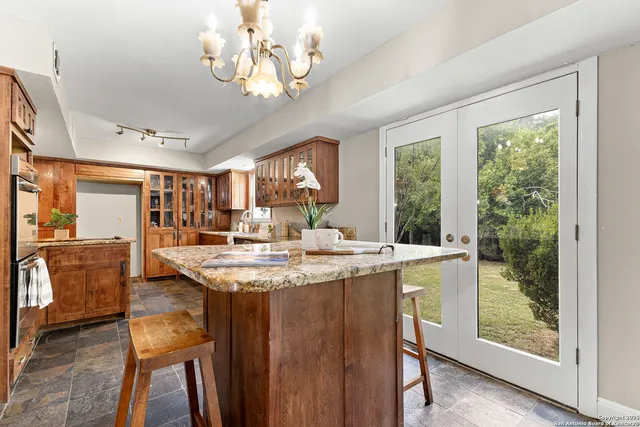 a kitchen with stainless steel appliances granite countertop counter space and a dining table
