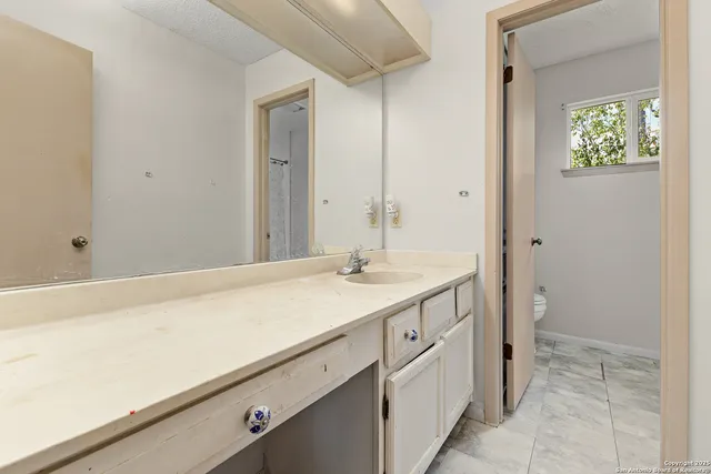 a bathroom with a sink and a mirror