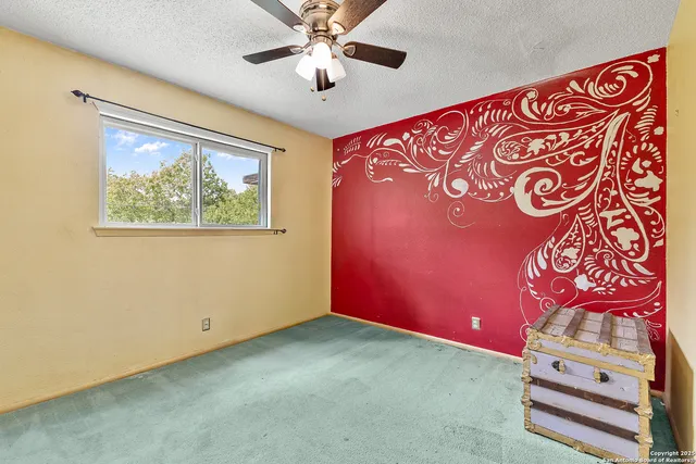 a view of an empty room with a fan