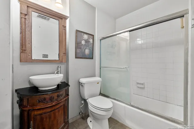 a bathroom with a toilet a sink and shower