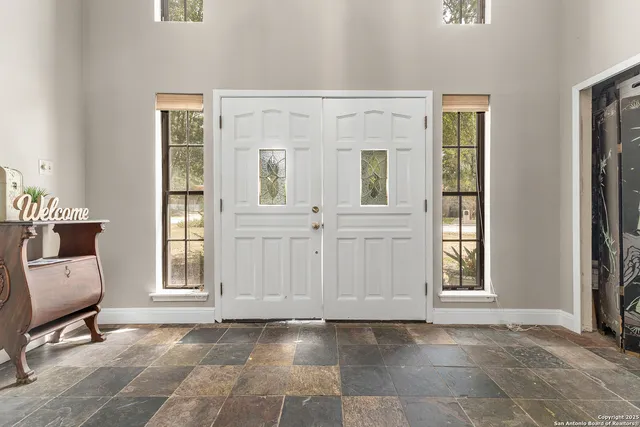 a view of a room with windows and cabinet