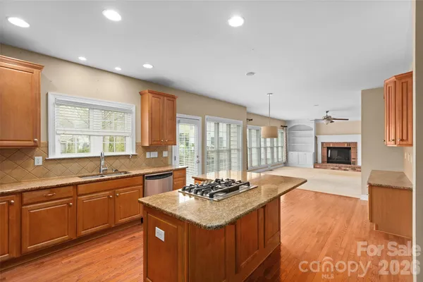a kitchen with a sink stove and wooden cabinets