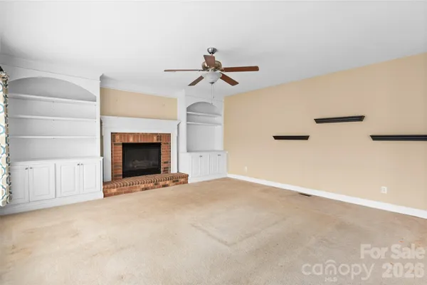 a view of empty room with fireplace