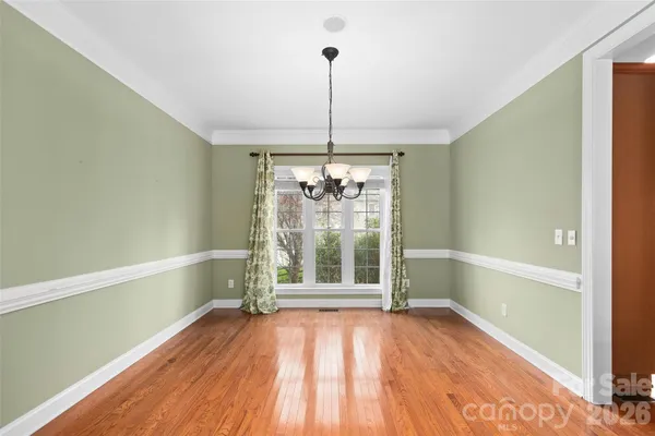 a view of a room with wooden floor fan and window