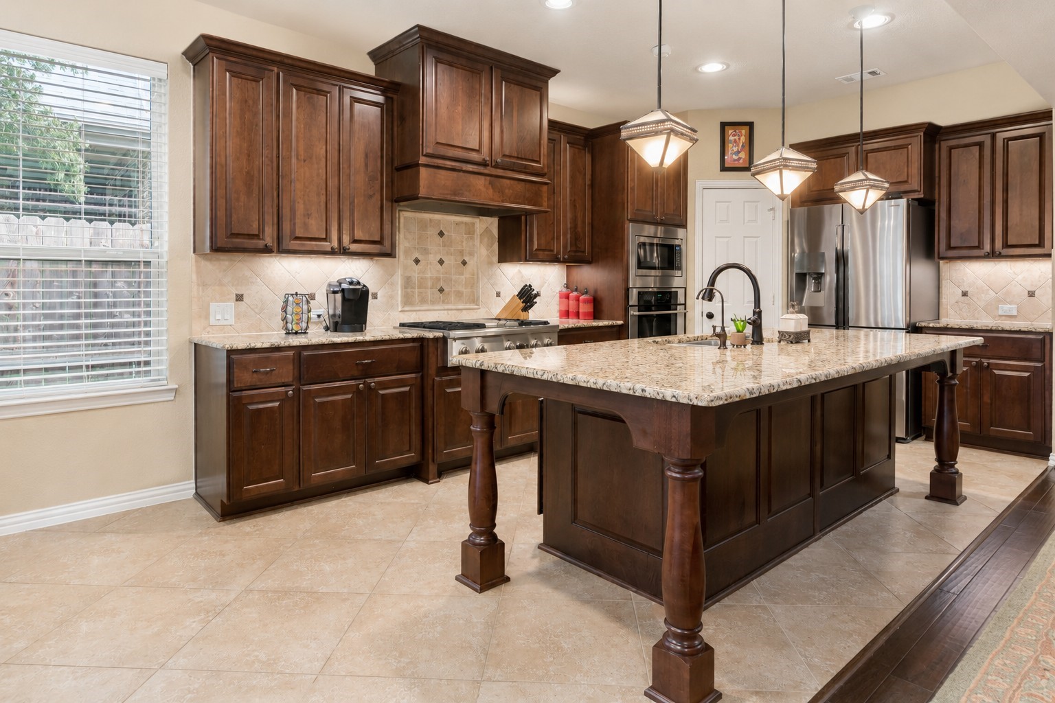 2326 Hamilton Pool Lane Friendswood, TX 77546 - Photo 17 of 49 a kitchen with stainless steel appliances granite countertop a sink a stove a refrigerator cabinets and wooden floor