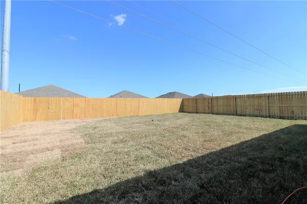 a view of an outdoor space and wooden fence