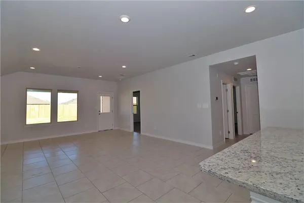 an empty room with windows and closet