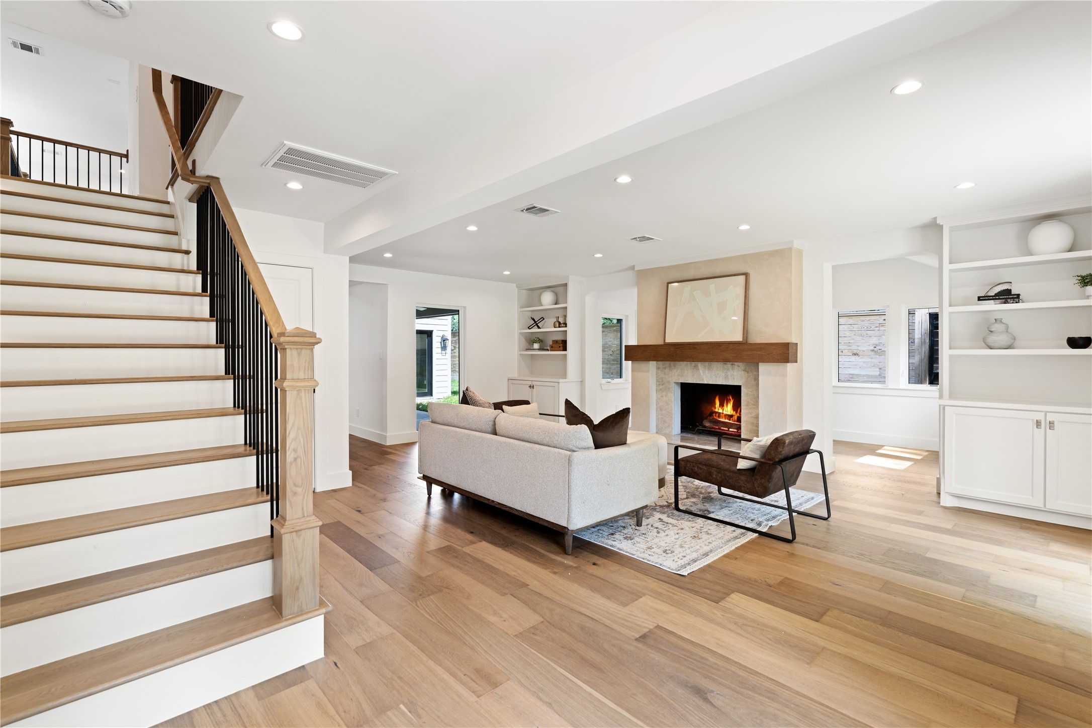 814 Azalea Street Houston, TX 77018 - Photo 4 of 31 Inviting living room featuring custom built-ins and a cozy fireplace as the centerpiece