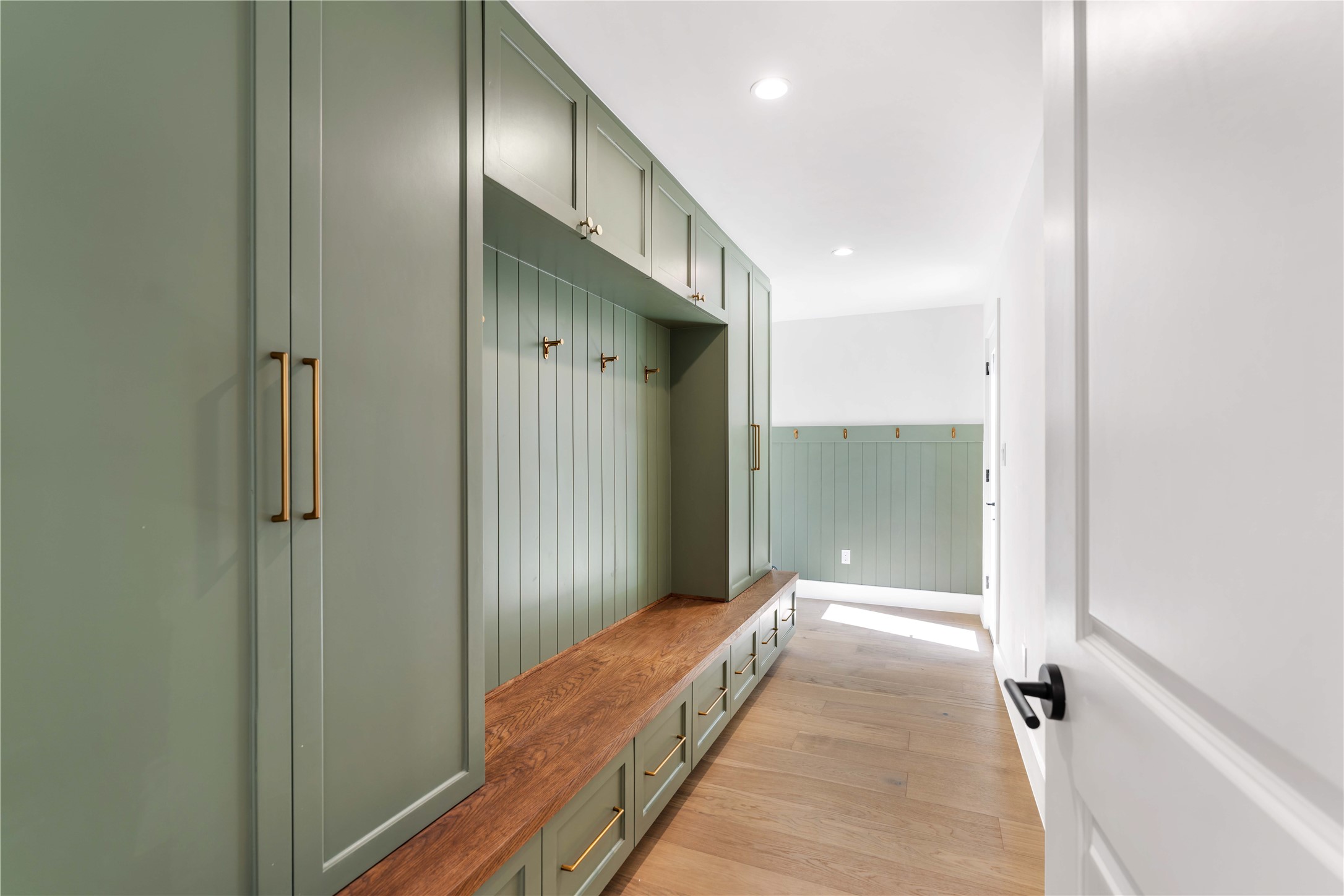 814 Azalea Street Houston, TX 77018 - Photo 8 of 31 Mudroom with built-in storage and bench seating, conveniently located off the garage with additional access to the backyard.