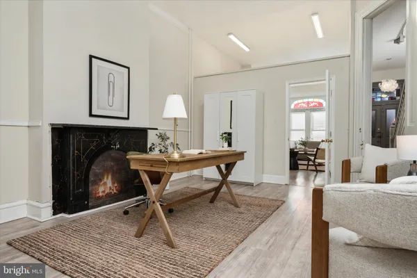 a living room with furniture a rug and a fireplace