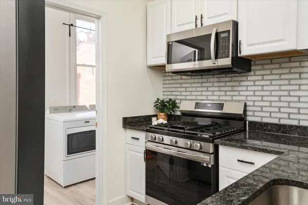 a kitchen with a stove and a microwave