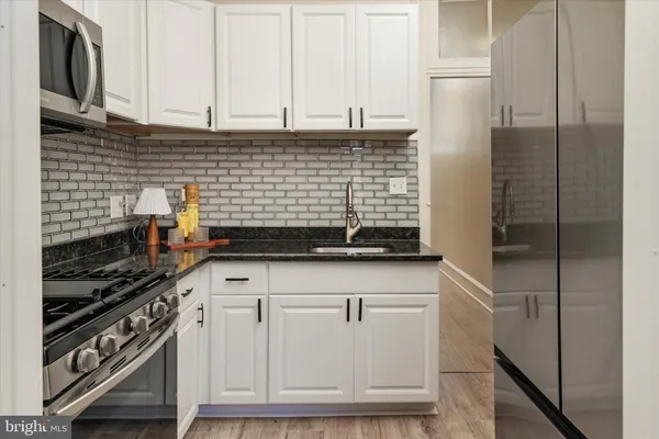 a kitchen with stainless steel appliances cabinets and a counter top space