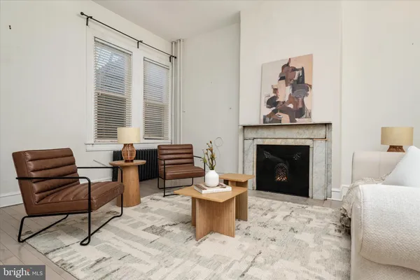 a living room with furniture and a fireplace
