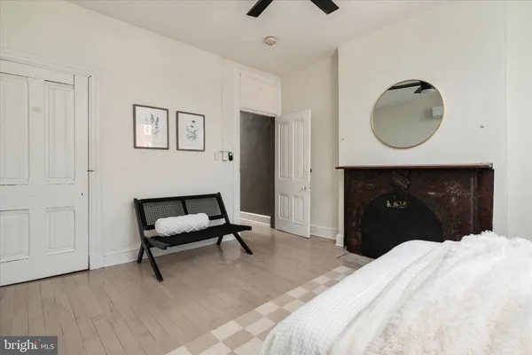 a bedroom with a bed and a mirror