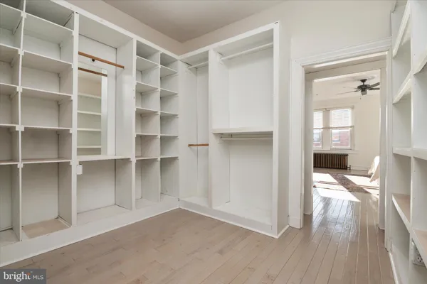 a view of walk in closet with empty racks