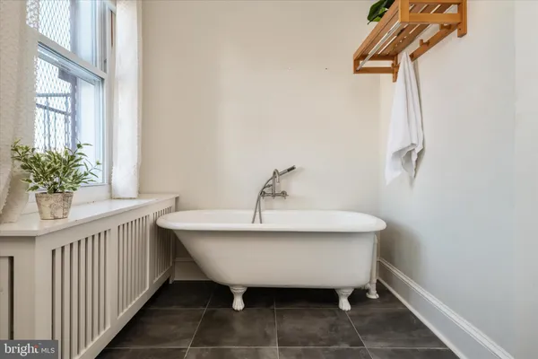 a spacious bathroom with a sink and mirror