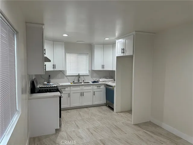 a kitchen with a sink stove and refrigerator