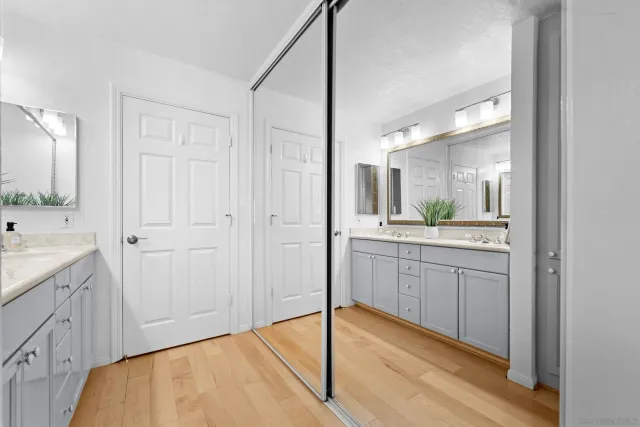 a bathroom with a granite countertop sink mirror and