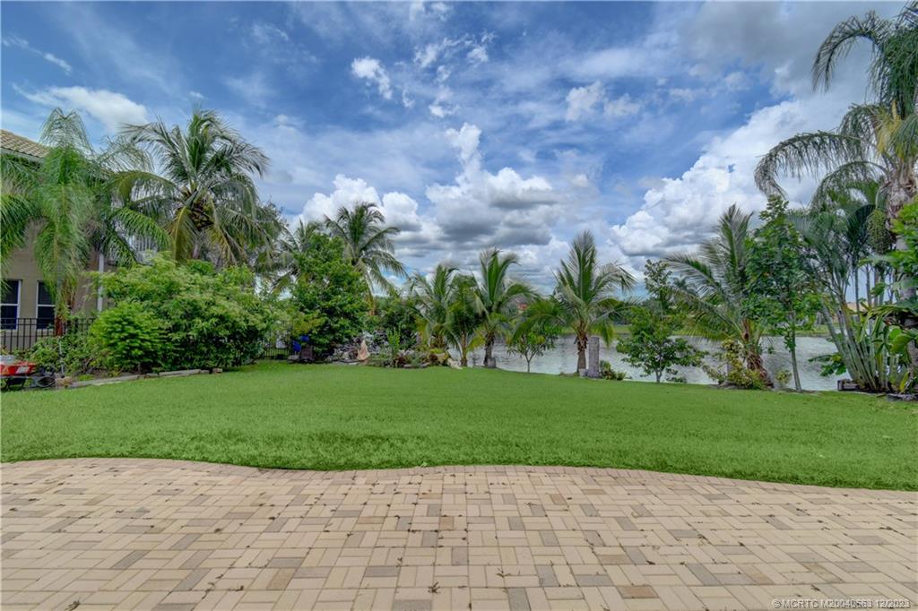 2171 Southwest Panther Trace Stuart, FL 34997 - Photo 26 of 26 Lake view, fruit trees, and koi pond