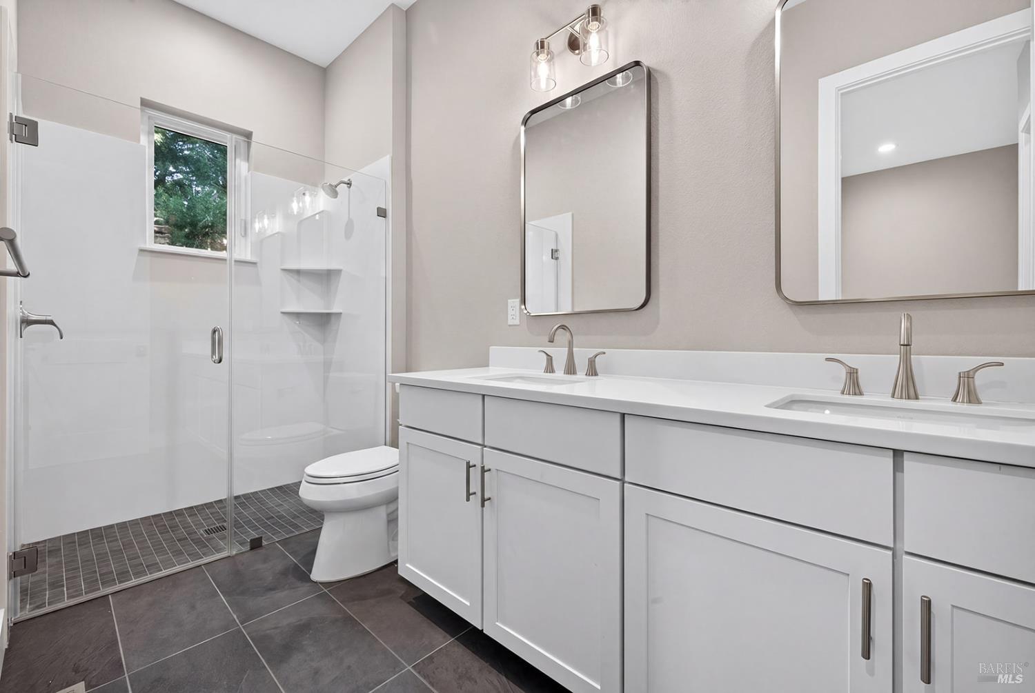 1913 Carlile Place Santa Rosa, CA 95403 - Photo 27 of 60 View of the main level primary suite bathroom. Double sink vanity and curb less shower for easy access.
