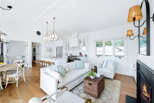 a living room with furniture a chandelier and a window