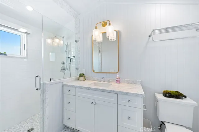 a bathroom with a sink mirror and vanity