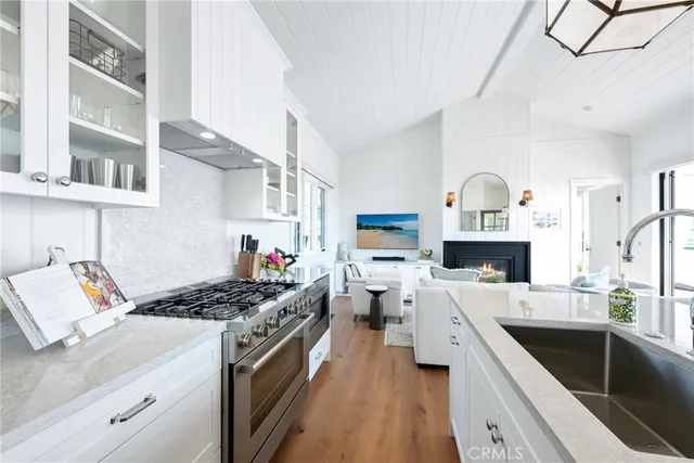 a kitchen with a sink stove and cabinets