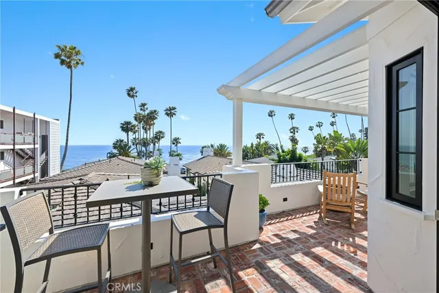 a view of an outdoor dining space with a table and chairs