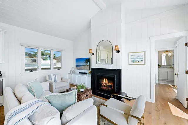 a living room with furniture fireplace and a window