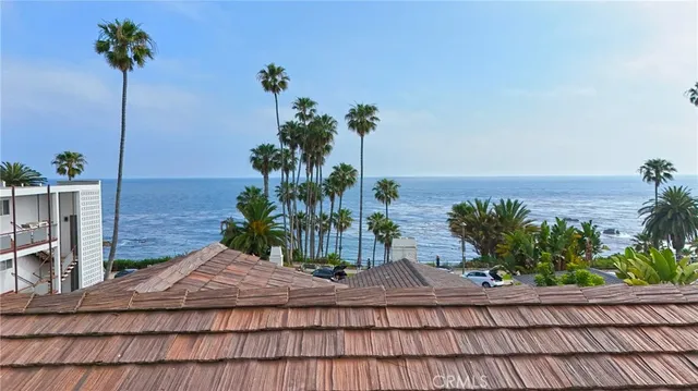 a vase of flowers sitting on a table with a potted plant