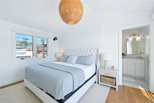 a bedroom with a bed and a painting on the wall