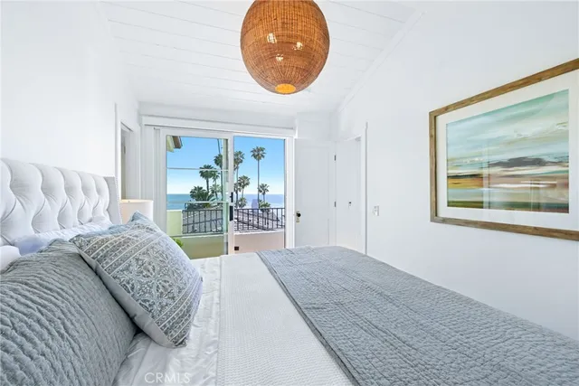 a spacious bedroom with a large bed and a large window