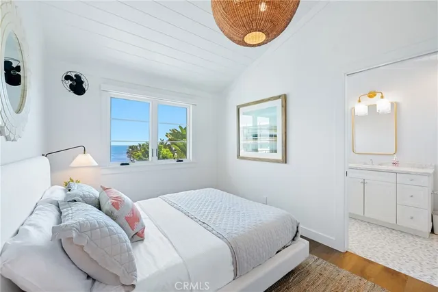 a bedroom with a bed and a mirror