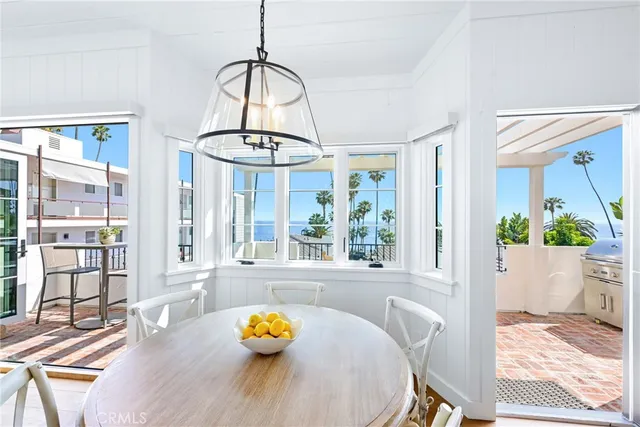 a view of a dining room with furniture a chandelier and wooden floor