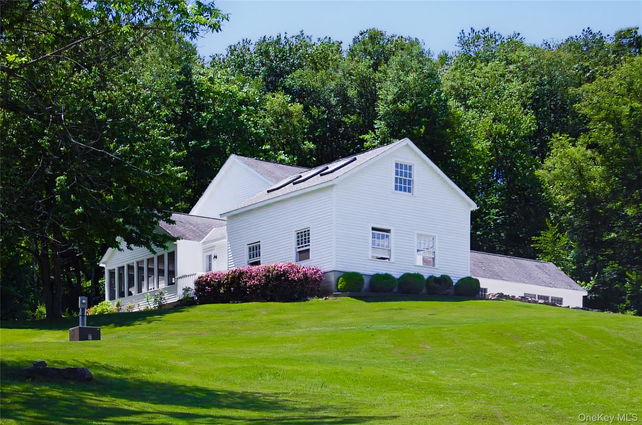 a front view of house with yard and green space