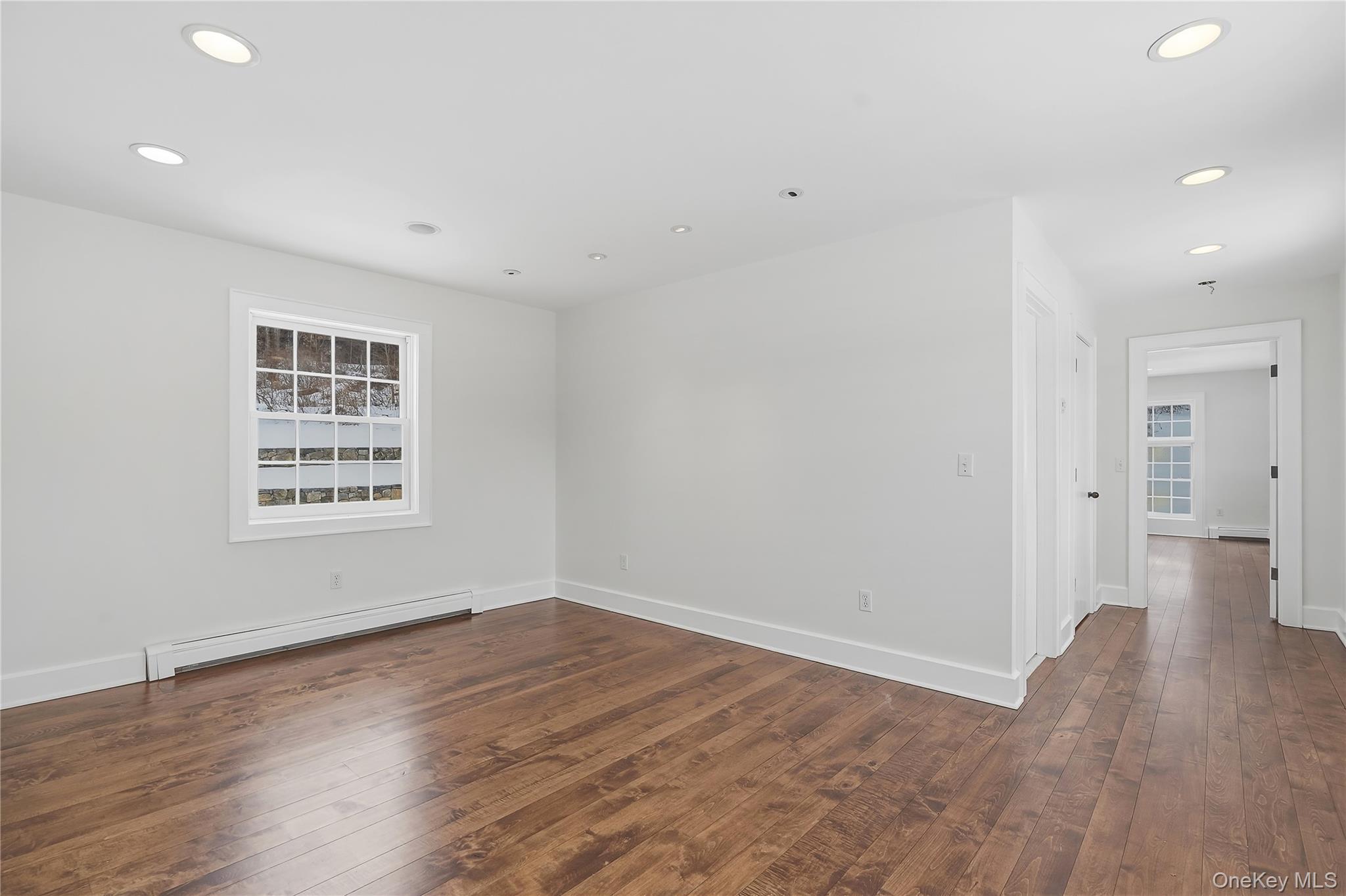 492 Mooney Hill Road, Unit 490 Patterson, NY 12563 - Photo 12 of 18 a view of an empty room with wooden floor and a window