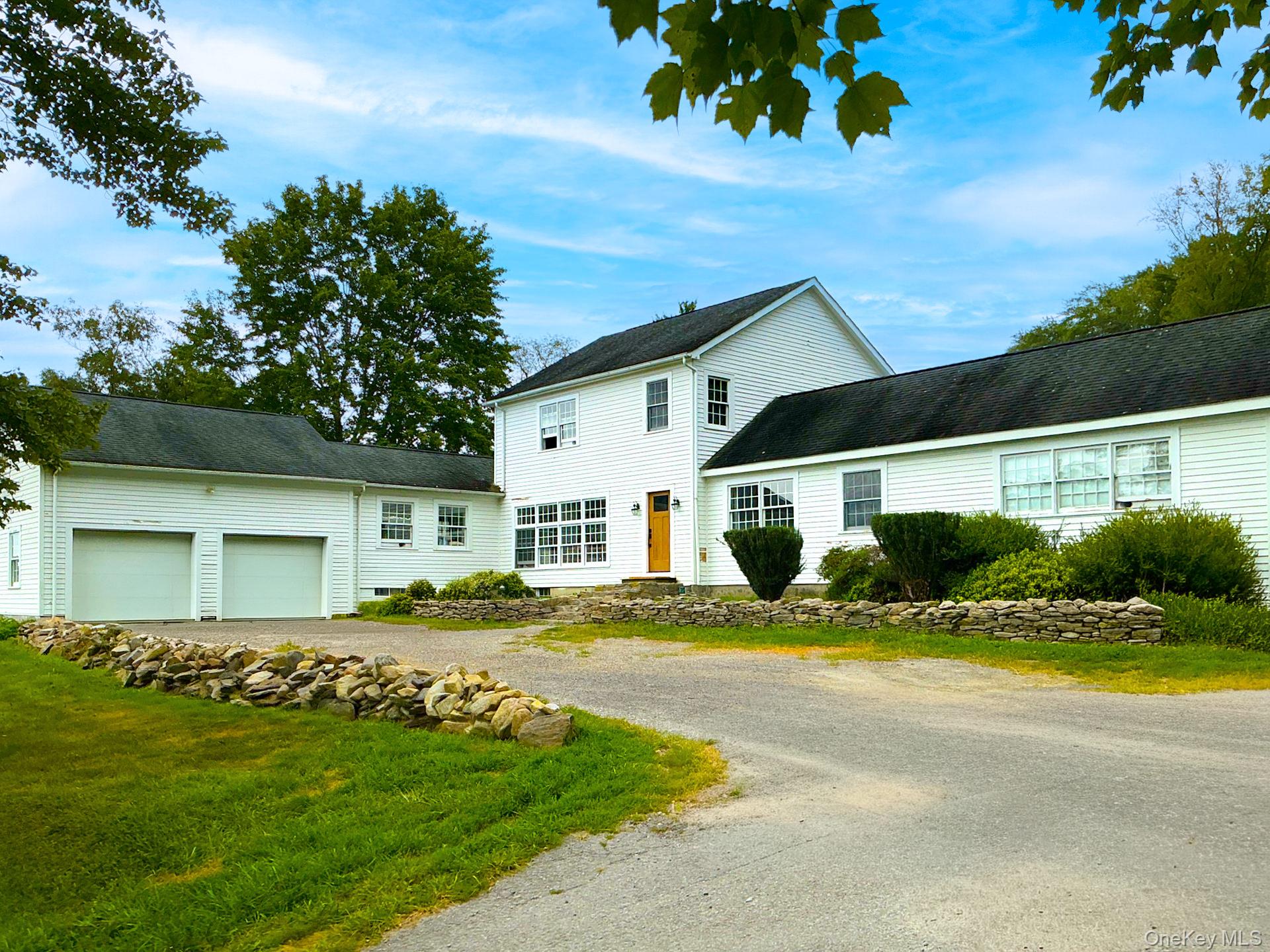 492 Mooney Hill Road, Unit 490 Patterson, NY 12563 - Photo 16 of 18 a front view of a house with a yard
